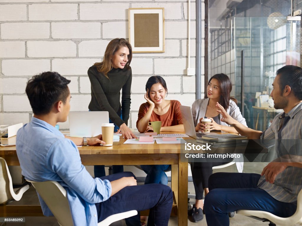multiethnic business team meeting in office a team of multinational people discussing business in glass meeting room. Meeting Stock Photo