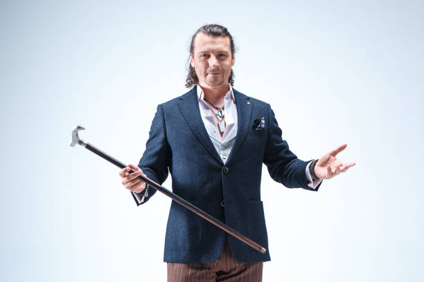 istock The mature barded man in a suit holding cane 855485272