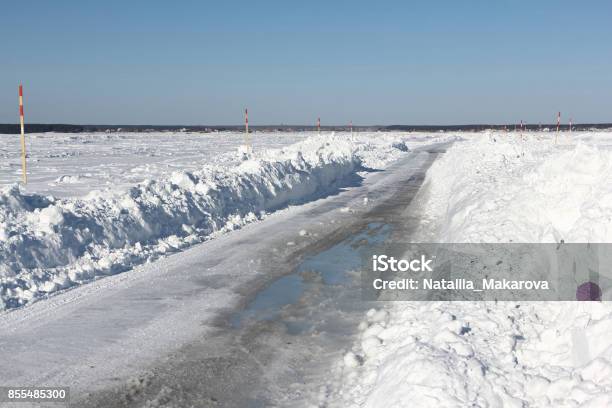 Ice Road Melting On A Frozen Reservoir In Winter Stock Photo - Download Image Now - Agricultural Field, Backgrounds, Blue