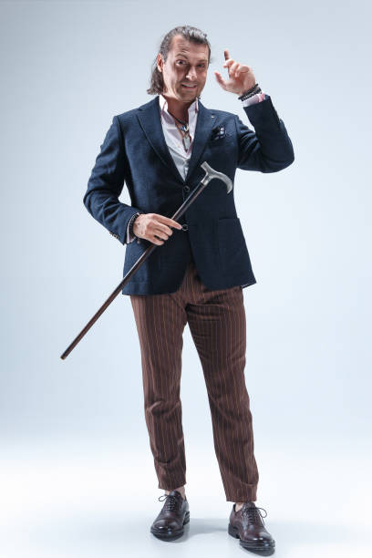 istock The mature barded man in a suit holding cane 855485312