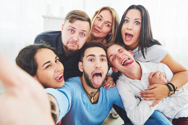 Best friends taking selfie outdoors with backlighting - Happy friendship concept with young people having fun together