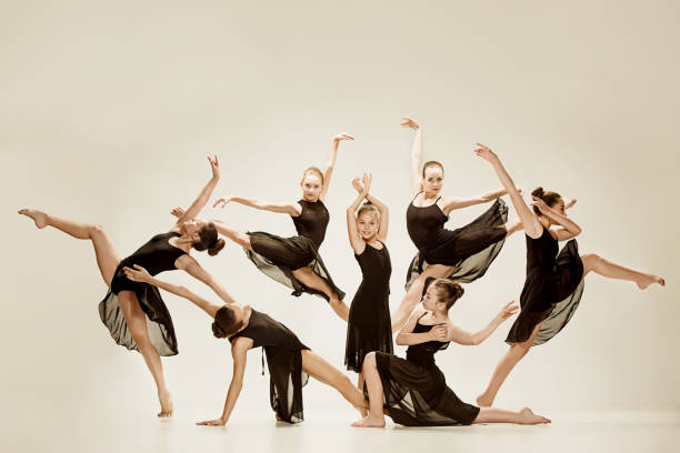 The group of modern ballet dancers The group of modern ballet dancers dancing on gray studio background dance music photos stock pictures, royalty-free photos & images