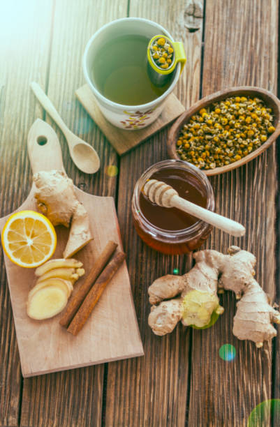istock Ginger root tea with chamomile lemon and honey on wooden background 855486042