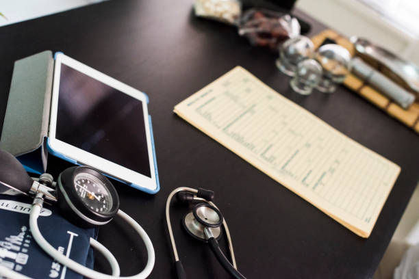 istock Acupuncture. Close up of table with tablet and notepad 855486076