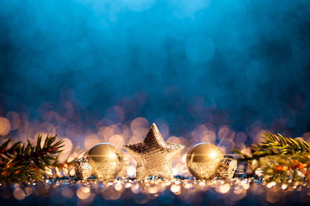 Decorative christmas still life. Abstract christmas trees on gold and blue glitter background.