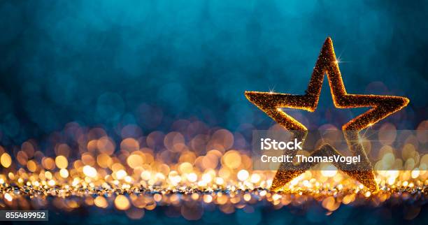 Christmas Star Defocused Decoration Gold Blue Bokeh Background Stock Photo - Download Image Now