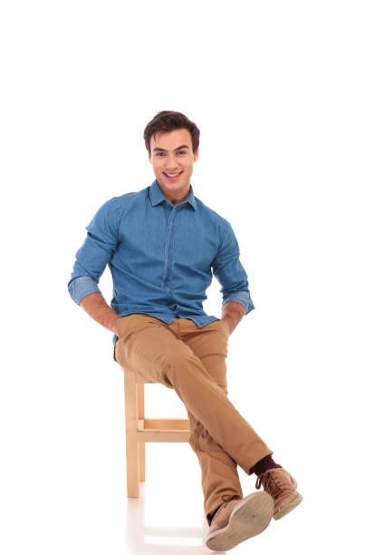 istock happy seated man with hands in pockets is laughing 855490110