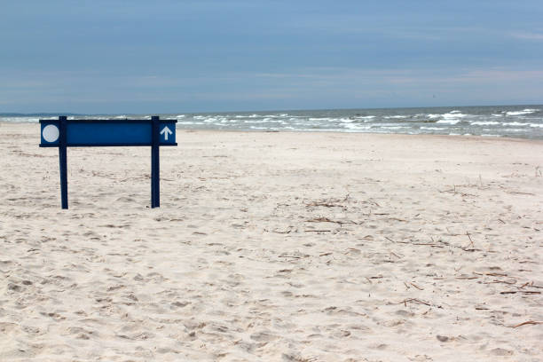 istock Sandy beach with a blue sign on the Baltic sea 855494300