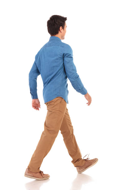 istock back side view of a walking young casual man 855494564