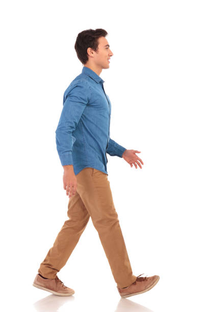 istock side view of a confident casual man walking forward 855494662