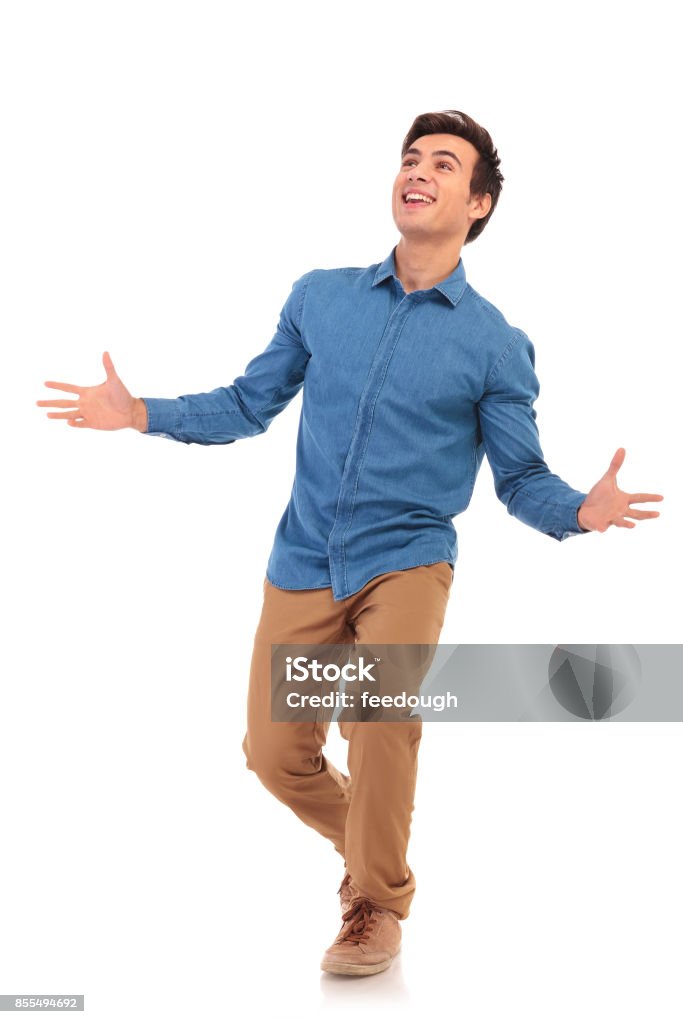 walking casual man welcoming and looking up amazed walking casual man welcoming and looking amazed to upper side on white background Men Stock Photo