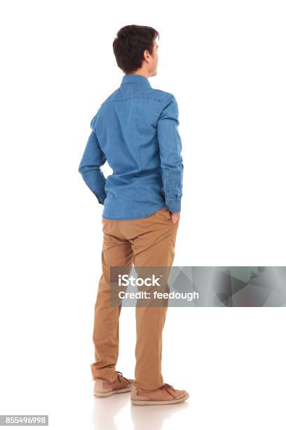 Back View Of A Casual Man With Hands In Pockets Stock Photo - Download Image Now - Rear View, Men, Back