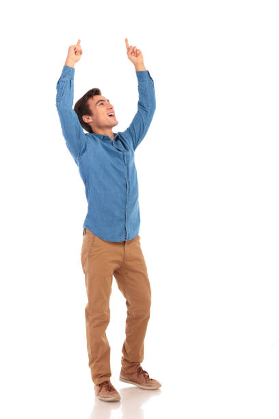 istock happy casual man celebrating victory with hands in the air 855497182