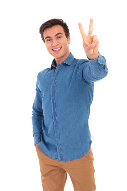 istock happy casual man making the victory or peace hand sign 855497304