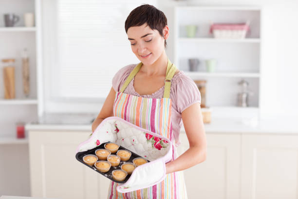 istock Charming brunette woman showing muffins 855497960
