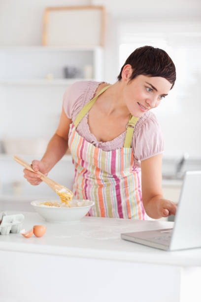 istock Cute Woman looking at a receipt on a laptop 855498024