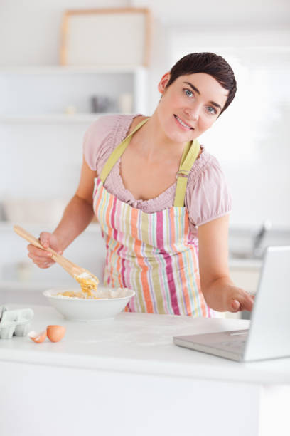 istock Smiling Woman looking at a receipt on a laptop 855498034