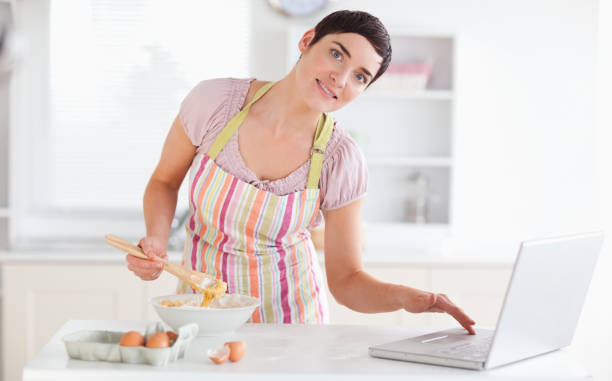istock Charming Woman looking at a receipt on a laptop 855498042