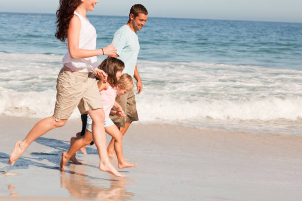 istock Family running on the beach 855505532