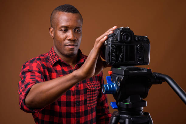 istock Studio shot of muscular African man getting ready for vlogging against colored background 855505558