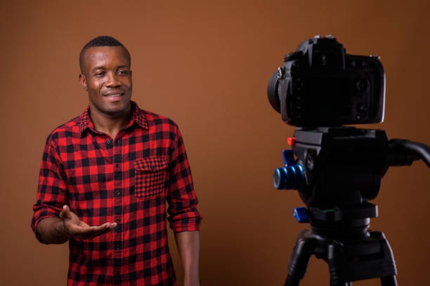 istock Studio shot of muscular African man vlogging against colored background 855507742
