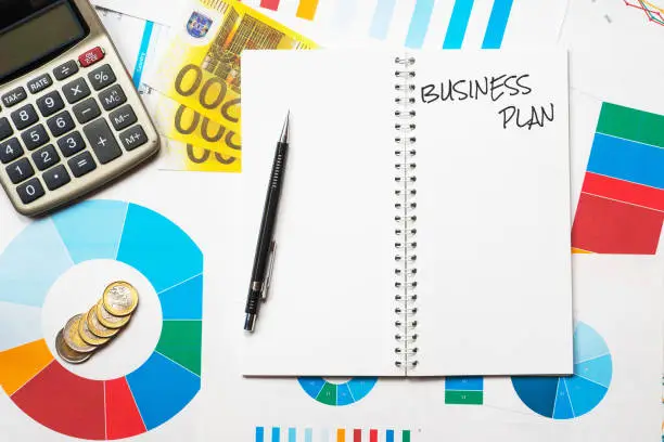 business plan title on colorful charts, calculator and euro money background