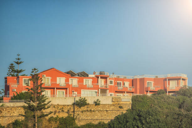 istock Red colored apartments in Greece with blue sunny sky at the background 855508128