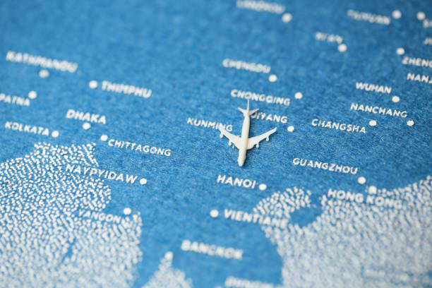 istock airplane fly on the blue painted map ,hanoi 855509220