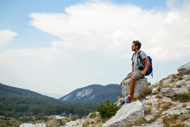 istock Young man enjoying a beautiful view in the nature 855512916