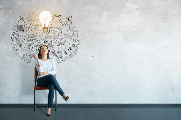 Leadership concept Thoughtful young woman sitting in concrete interior with creative business sketch and shadow. Leadership concept drawing art product photos stock pictures, royalty-free photos & images
