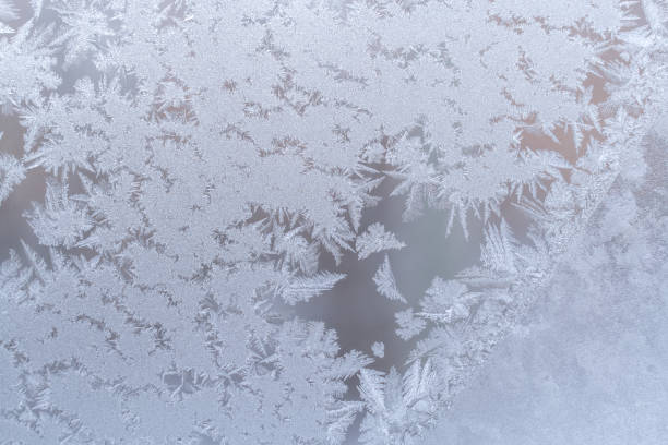 istock Gentle graceful frosty pattern on winter window glass. 855517264