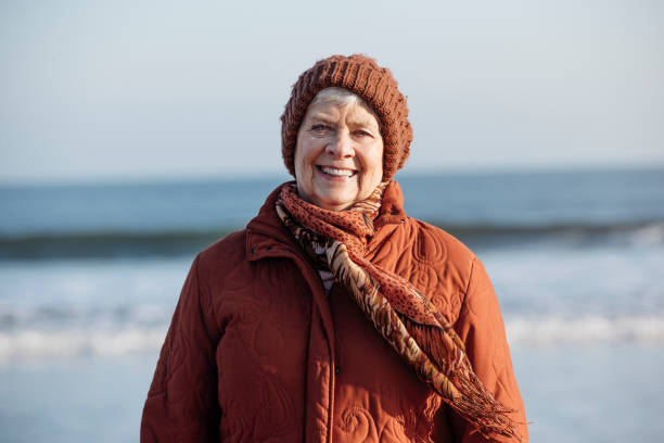 istock Senior Woman Wrapped Up on the Beach During Winter 855517270