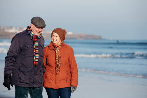 istock Senior Couple Taking a Walk Along the Beach 855517448