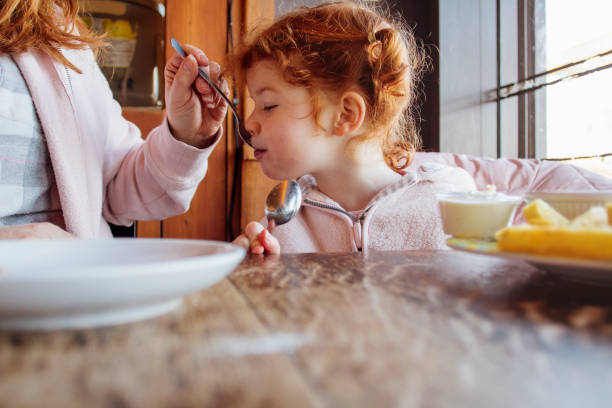 istock Mother and Daughter Eating in a Beach Cafe 855520730