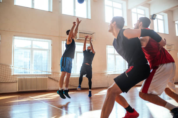 Dedicated to the game Basketball players playing basketball indoors. defending sport stock pictures, royalty-free photos & images