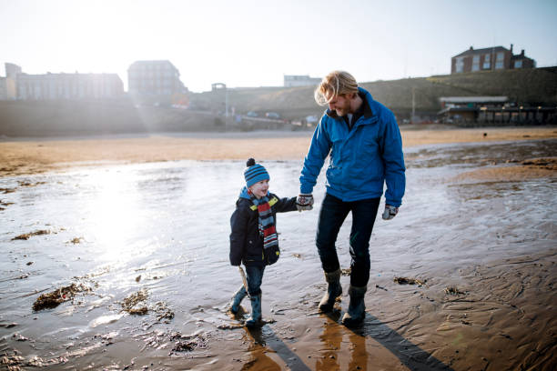 istock Father and Son Walking hand in Hand on a Beach 855521122