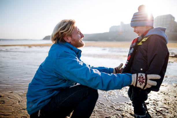 istock Father and Son Spending their Day on the Beach on a Winter's Day 855521246