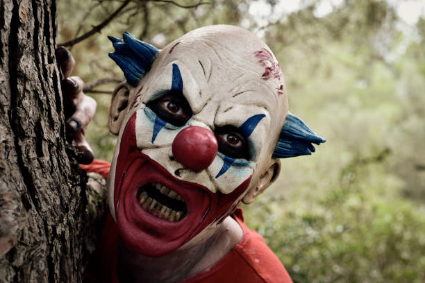istock scary evil clown in the woods 855524412