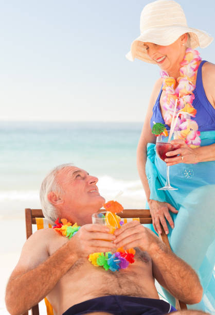 istock Couple drinking cocktails at the beach 855525328
