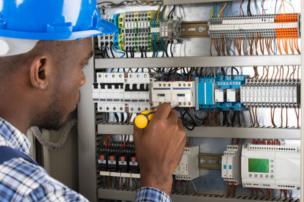 Electrician Examining Fusebox With Screwdriver Close-up Of Young Male Technician Examining Fusebox With Screwdriver screwdriver photos stock pictures, royalty-free photos & images
