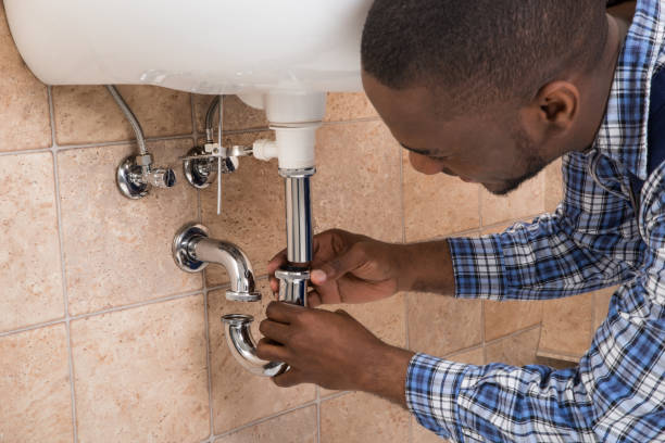 istock Plumber's Hand Fixing Sink In Bathroom 855529206
