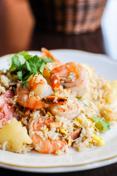 istock Pineapple Fried Rice, Stir-fried rice with egg, pineapple, raisins, cashew nuts, green onions and tomatoes. 855536066