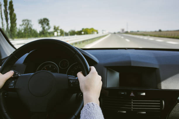 istock Driving car on highway. Hands on steering wheel inside of a car 855536864