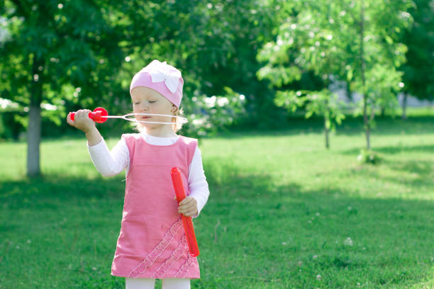 istock A little girl is learning to blow bubbles. 855536964