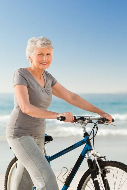 istock Senior woman with her bike 855539952