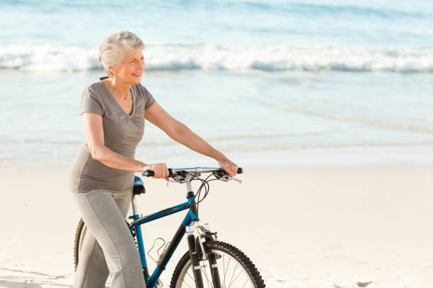 istock Senior woman with her bike 855539990