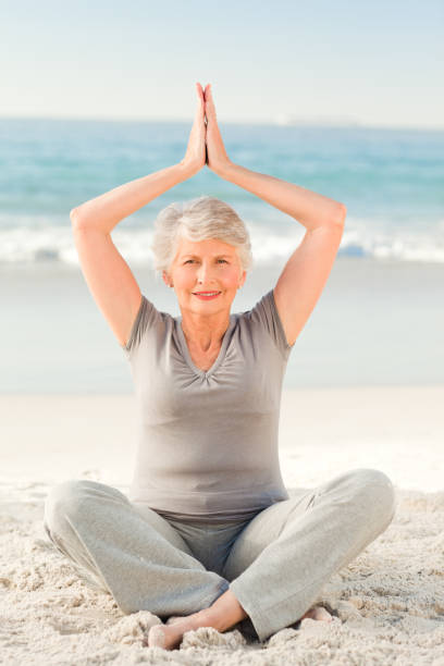 istock Elderly woman doing her streches 855540432