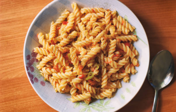 hot sauce and pasta with vegetables stock photo