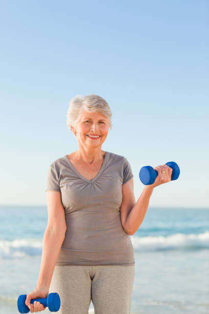 istock Woman doing her exercises at the beach 855540808