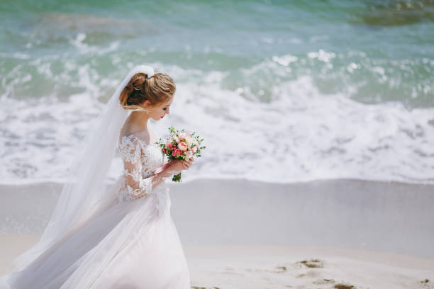 happy wedding couple in suit and white dress, hugging, walking after the ceremony.